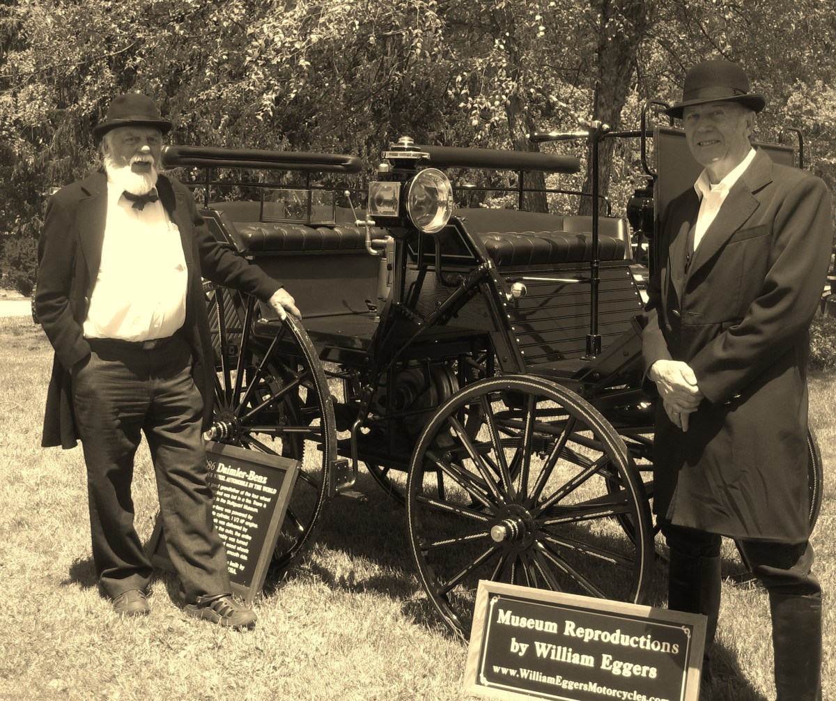 Two men in period dress with antique car