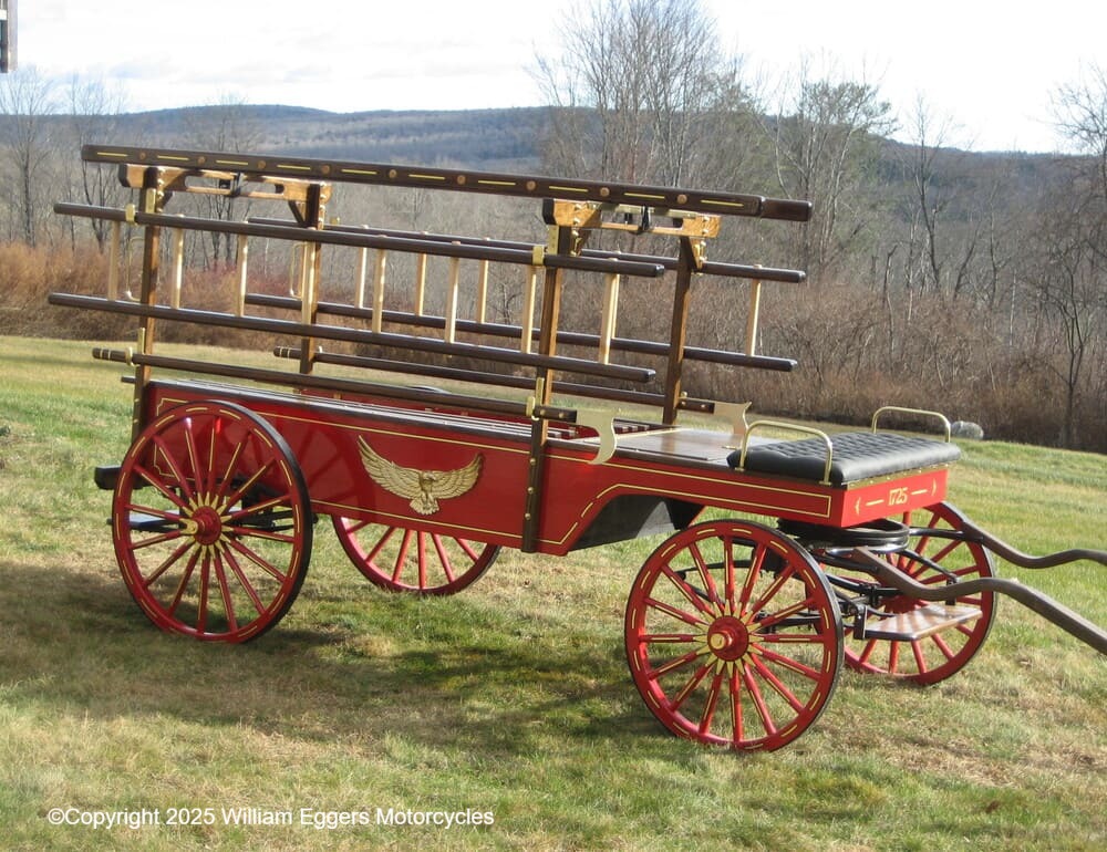 Side view of a hook and ladder fire truck.